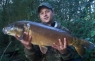 17lb mirror carp stalked under a tree.